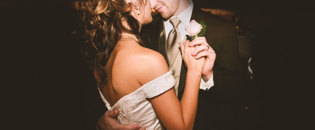 Newlyweds dancing holding each other